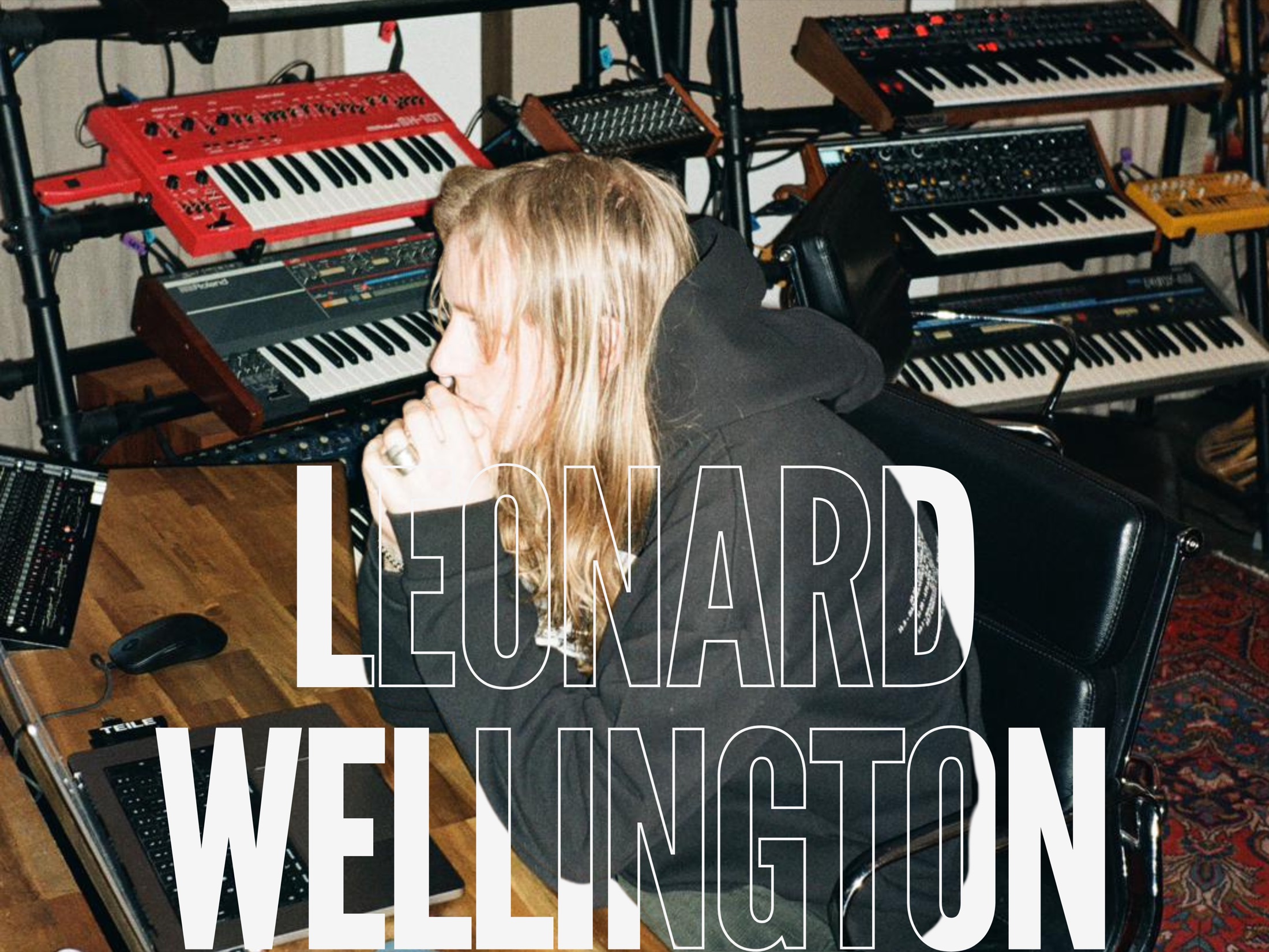 Leonard Wellington working in his Berlin studio, surrounded by synthesizers